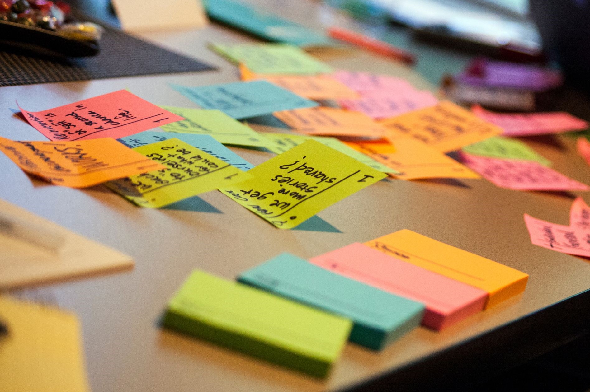 post-it notes scattered on a desk